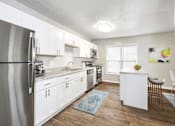 Thumbnail 9 of 19 - Open concept kitchen with quartz countertops and island seating at Hyde Park Townhomes, PRG Real Estate Management, Chester, 23831