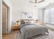 Thumbnail 24 of 26 - A bedroom with a bed, two lamps, and a ceiling fan at The Point Apartments on 38th, Norfolk, Virginia
