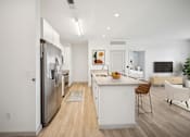 Thumbnail 18 of 25 - A modern kitchen with white appliances and a wooden floor at Circ Apartments, Virginia