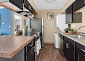 Thumbnail 20 of 32 - Kitchen Area with Washer and Dryer at the Grove at Lyndon Apartments Louisville KY