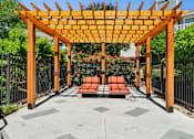 Thumbnail 7 of 21 - Pool side wooden pergola at Palmetto Place Apartments