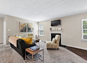 Thumbnail 8 of 21 - a living room with a couch and a coffee table at Palmetto Place Apartments, Taylors, 29687