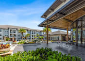 Thumbnail 11 of 29 - Patio with Tables and Chairs at The Loree, Jacksonville, FL, 32256