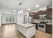 Thumbnail 18 of 35 - Modern Kitchen with Large Island at Park at Rialto Apartments, San Antonio