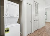 Thumbnail 30 of 39 - A white tankless water heater with a yellow sticker on it.