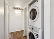 Thumbnail 17 of 29 - Stacked washer and dryer system in closet at Sundancer Apartments, Arizona, 85353