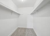 Thumbnail 14 of 26 - A room with white walls and a carpeted floor.