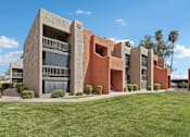 Thumbnail 21 of 26 - A modern building with a red and beige exterior.