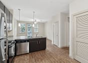 Thumbnail 23 of 39 - Modern Kitchen and and Spacious Living Room at District at Medical Center, San Antonio