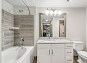Thumbnail 22 of 35 - Modern Bathroom with Tub at Park at Rialto Apartments, San Antonio