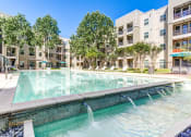 Thumbnail 3 of 31 - Resort Style Pool & BBQ Grill Area at District at Medical Center, San Antonio