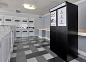 Thumbnail 14 of 16 - A laundry room with a black and white checkered floor. at North Mountain Apartments, Arizona, 85020