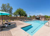 Thumbnail 3 of 10 - our apartments have a resort style pool with lounge chairs and umbrellas