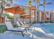 Thumbnail 26 of 26 - A poolside area with sun loungers and umbrellas.