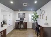 Thumbnail 24 of 24 - A kitchen with a white counter top and wooden floors.