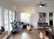 Thumbnail 3 of 16 - A living room with a grey couch and a brown coffee table at North Mountain Apartments, Phoenix, AZ, 85020