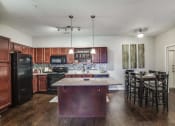 Thumbnail 7 of 19 - Kitchen with Island (most units come with an kitchen island)  at Overlook at Stone Oak Park Apartments, San Antonio, 78258