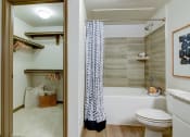 Thumbnail 12 of 35 - Upgraded Bathroom with Tile Surround Tub & Large Closet at Park at Rialto Apartments, San Antonio