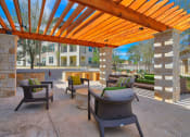 Thumbnail 5 of 35 - Outdoor Patio Under Pergola & Grilling Station at Park at Rialto Apartments, San Antonio