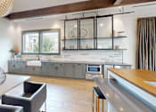 Thumbnail 13 of 48 - a clubhouse kitchen with gray cabinets and a table and chairs
