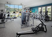 Thumbnail 18 of 48 - a gym with exercise equipment and windows in a building