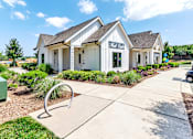 Thumbnail 24 of 48 - an exterior view of a white building with a sidewalk