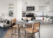 Thumbnail 34 of 48 - a kitchen and dining area with a table and chairs