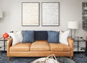 Thumbnail 37 of 48 - a living room with a couch and two pictures on the wall