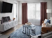 Thumbnail 38 of 48 - a living room with a couch and a table