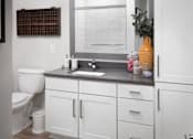 Thumbnail 40 of 48 - a white bathroom with a sink and a window