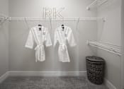 Thumbnail 42 of 48 - two white robes hanging in a walk-in closet