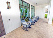 Thumbnail 47 of 48 - a row of blue chairs outside of a building