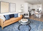 Thumbnail 5 of 48 - a living room with a couch and a table