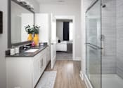 Thumbnail 6 of 48 - a bathroom with a shower and a sink and a mirror