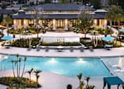 Thumbnail 53 of 60 - Clubhouse and swimming pool at twilight at Avli At Crosstown Center Apartments, TAMPA, FL
