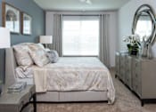 Thumbnail 58 of 60 - Spacious bedroom with large window and dresser at Avli At Crosstown Center Apartments, TAMPA, 33619