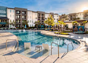 Thumbnail 57 of 60 - Pool with sun shelf loungers and handrails at Avli At Crosstown Center Apartments, TAMPA, FL 33619