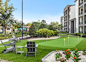 Thumbnail 52 of 60 - Outdoor putting green with adirondack chairs and courtyard at Avli At Crosstown Center Apartments, TAMPA, 33619