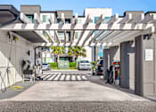 Thumbnail 31 of 60 - Covered ev charging station with pergola design at Avli At Crosstown Center Apartments, TAMPA, FL 33619