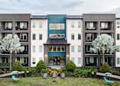 Thumbnail 35 of 60 - Modern apartment building with courtyard and palm trees at Avli At Crosstown Center Apartments, Florida, 33619