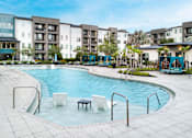 Thumbnail 33 of 60 - Resort style pool with cabanas and tropical landscaping at Avli At Crosstown Center Apartments, TAMPA, FL 33619