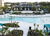 Thumbnail 27 of 60 - Resort style pool with clubhouse and lounge seating at Avli At Crosstown Center Apartments, TAMPA, FL