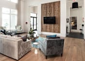 Thumbnail 30 of 60 - Clubhouse lounge with wood accent wall and television at Avli At Crosstown Center Apartments, Florida, 33619