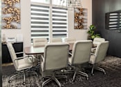 Thumbnail 49 of 60 - Conference room with oval table and leather chairs at Avli At Crosstown Center Apartments, TAMPA, FL 33619