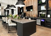 Thumbnail 37 of 60 - Modern kitchen island with pendant lights and bar seating at Avli At Crosstown Center Apartments, TAMPA