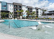 Thumbnail 23 of 60 - Swimming pool with wading area and modern water features at Avli At Crosstown Center Apartments, TAMPA