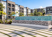 Thumbnail 11 of 60 - Water feature wall with stone base and landscaping at Avli At Crosstown Center Apartments, Florida, 33619