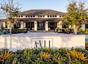 Thumbnail 5 of 60 - Property entrance monument sign with modern landscaping at Avli At Crosstown Center Apartments, TAMPA, FL