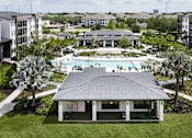 Thumbnail 12 of 60 - Outdoor pavilion with pool and clubhouse views at Avli At Crosstown Center Apartments, TAMPA, Florida