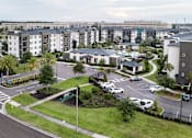 Thumbnail 15 of 60 - Aerial view of apartment buildings and community entrance at Avli At Crosstown Center Apartments, TAMPA